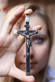 Teenage girl holding a crucifix, Saint Gervais, Haute Savoie, france, Europe Teenage girl holding a crucifix, Saint Gervais, Haute Savoie, france, Europe