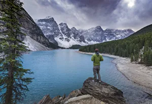Tourist watching the scenery of the Moraine Lake, Banff National Park, UNESCO World Heritage Site Tourist watching the scenery of the Moraine Lake, Banff National Park, UNESCO World Heritage Site
