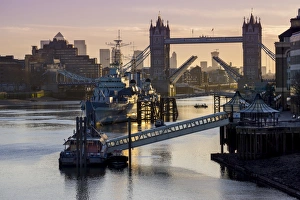 Tower Bridge raising deck with HMS Belfast on the River Thames, London, England, United Kingdom Tower Bridge raising deck with HMS Belfast on the River Thames, London, England, United Kingdom