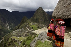 Traditionally dressed children looking over the ruins of the Inca city of Machu Picchu, UNESCO World Heritage Site Traditionally dressed children looking over the ruins of the Inca city of Machu Picchu, UNESCO World Heritage Site