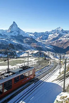 A train from Zermatt approaching the Gornergrat Station facing the majestic shape of the Matterhorn, Valais A train from Zermatt approaching the Gornergrat Station facing the majestic shape of the Matterhorn, Valais