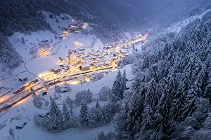 Trees covered with snow in the winter forest surrounding the alpine village at Christmas Trees covered with snow in the winter forest surrounding the alpine village at Christmas