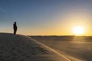 Tuareg standing on a sand dune in the Tenere Desert at sunrise, Sahara, Niger, Africa Tuareg standing on a sand dune in the Tenere Desert at sunrise, Sahara, Niger, Africa