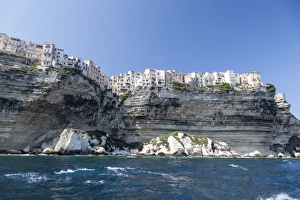The turquoise sea frames the ancient village perched on the white cliffs, Bonifacio The turquoise sea frames the ancient village perched on the white cliffs, Bonifacio