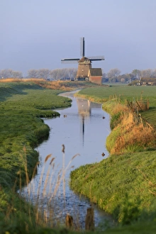 Colourful European Scenery Prints: Typical windmill reflected in the canal at dawn, Berkmeer, municipality of Koggenland