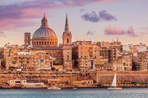 Valletta skyline at sunset with the Carmelite Church dome and St. Pauls Anglican Cathedral, Valletta, Malta Valletta skyline at sunset with the Carmelite Church dome and St. Pauls Anglican Cathedral, Valletta, Malta