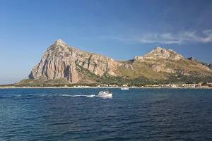 View across the bay to Monte Monaco and Pizzo di Sella, small boat returning to port View across the bay to Monte Monaco and Pizzo di Sella, small boat returning to port