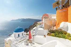 View of blue domed church from cafe in Oia village, Santorini, Aegean Island, Cyclades Island View of blue domed church from cafe in Oia village, Santorini, Aegean Island, Cyclades Island
