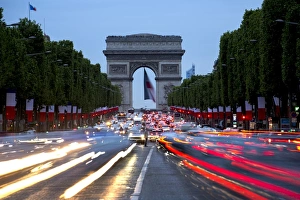 Illuminated Cityscape Prints: View down the Champs Elysees to the Arc de Triomphe, illuminated at dusk, Paris, France