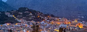 Majorca Balearic Islands Prints: View of churches and rooftops of Pollenca with mountain in background at dusk
