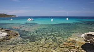 View across clear turquoise water from rocky coastline near the Plage du Loto, St-Florent, Haute-Corse, Corsica, France View across clear turquoise water from rocky coastline near the Plage du Loto, St-Florent, Haute-Corse, Corsica, France