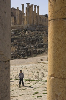 Jerash Archaeological Site Prints: View through columns of boy walking past