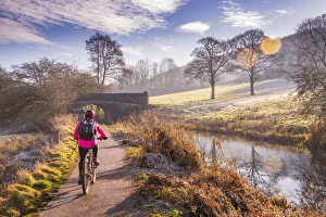 View of cyclist and frosty morning at the Cromford Canal, Derbyshire, England, United Kingdom, Europe View of cyclist and frosty morning at the Cromford Canal, Derbyshire, England, United Kingdom, Europe