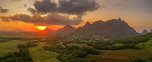 Indian Ocean Sunset Prints: View of golden sunset behind Long Mountain and patchwork of green fields