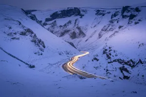 View of trail lights on snow covered Winnats Pass near Castleton, Derbyshire, England, United Kingdom, Europe View of trail lights on snow covered Winnats Pass near Castleton, Derbyshire, England, United Kingdom, Europe
