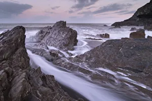 Waves surge around the jagged rocks on Wildersmouth Beach, Ilfracombe, Devon, England Waves surge around the jagged rocks on Wildersmouth Beach, Ilfracombe, Devon, England