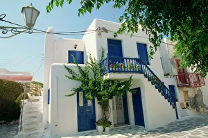 White house with blue doors and shutters on Mykonos White house with blue doors and shutters on Mykonos