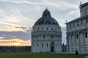 Woman admiring the majestic Pisa Cathedral (Duomo) and Baptistery at sunset Woman admiring the majestic Pisa Cathedral (Duomo) and Baptistery at sunset