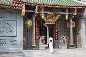 Woman wearing ao dai dress at Nghia An Hoi Quan Pagoda, Cholon, Ho Chi Minh City Woman wearing ao dai dress at Nghia An Hoi Quan Pagoda, Cholon, Ho Chi Minh City