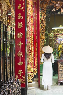 Woman wearing ao dai dress at Phuoc An Hoi Quan Pagoda, Cholon, Ho Chi Minh City Woman wearing ao dai dress at Phuoc An Hoi Quan Pagoda, Cholon, Ho Chi Minh City