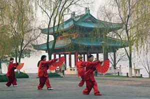 Women practising tai chi in front of a pavilion on West Lake, Hangzhou Women practising tai chi in front of a pavilion on West Lake, Hangzhou