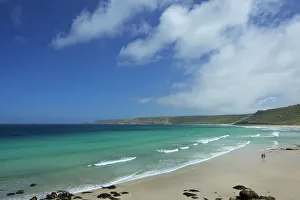 Young couple on beach at Sennen Cove in summer sunshine, West Penwith, Cornwall Young couple on beach at Sennen Cove in summer sunshine, West Penwith, Cornwall
