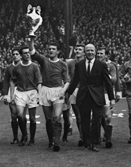 Bill Foulkes holds aloft the trophy alonside Matt Busby as the title-winning Manchester Bill Foulkes holds aloft the trophy alonside Matt Busby as the title-winning Manchester