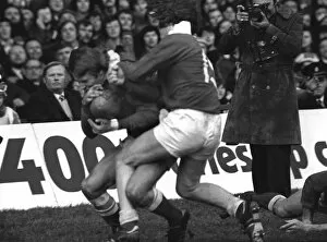 Images Dated 17th June 2006: JPR Williams makes his famous shoulder-barge tackle on Jean-Francois Gourdon - 1976 Five Nations