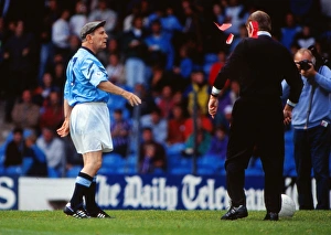 Norman Wisdom throws red cards at a referee Norman Wisdom throws red cards at a referee