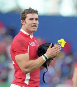 Prints of Rugby Union - 2011 Rugby World Cup - Wales vs. Samoa at Waikato Stadium, Hamilton. Leigh Halfpenny (Wales) after the match, holds a daffodil World War I Prints: Leigh Halfpenny holds a daffodil in this 2011 Rugby World Cup print