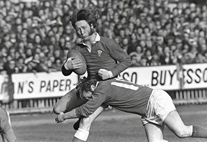 Images Dated 17th April 2007: Wales JPR Williams is tackled by Irelands Barry McGann - 1973 Five Nations