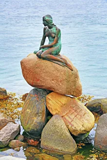 Little Mermaid statue sitting on rocks in Copenhagen, Denmark Little Mermaid statue sitting on rocks in Copenhagen, Denmark