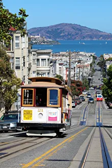 Street scene with a Cable Car tram and Alcatraz Prison island in San Franciso, California Street scene with a Cable Car tram and Alcatraz Prison island in San Franciso, California