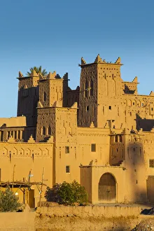 The 17th century Amerhidl kasbah illuminated at sunrise, Skoura, Morocco The 17th century Amerhidl kasbah illuminated at sunrise, Skoura, Morocco