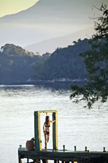 Angra dos Reis; Green Coast (Costa Verde) Ilha Grande, a model stands in an arch Angra dos Reis; Green Coast (Costa Verde) Ilha Grande, a model stands in an arch
