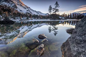 Autumn reflections at Saoseo Lake still partially frozen Poschiavo Valley Canton of Autumn reflections at Saoseo Lake still partially frozen Poschiavo Valley Canton of