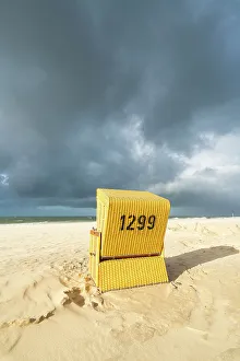 Schleswig Holstein Coastal Scenery Prints: Beach chair against cloudy dramatic sky