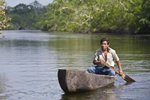 Belize, Lamanai, New River, Fisherman in dug out canoe Belize, Lamanai, New River, Fisherman in dug out canoe
