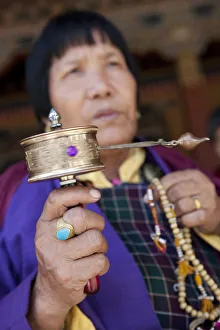 Bhutan. Devout Bhuddist worshippers with prayer wheels at the Gantey Gompa in Bhutan Bhutan. Devout Bhuddist worshippers with prayer wheels at the Gantey Gompa in Bhutan