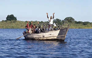 A boat ferries people across the Shire River A boat ferries people across the Shire River