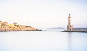 Bright sunrise over the Venetian lighthouse and Chania old town, Crete, Greece Bright sunrise over the Venetian lighthouse and Chania old town, Crete, Greece
