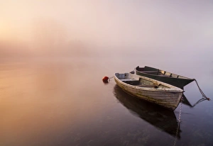 Brivio, Lombardy, Italy. Two boats on the Adda river at sunrise Brivio, Lombardy, Italy. Two boats on the Adda river at sunrise