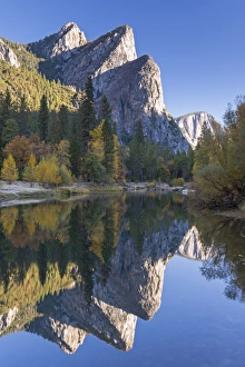 The Three Brothers reflected in the Merced River at dawn, Yosemite Valley, California, USA The Three Brothers reflected in the Merced River at dawn, Yosemite Valley, California, USA