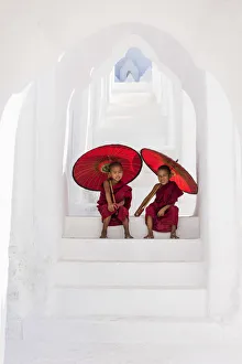 Two Buddhist novice monks on the steps of the white pagoda of Hsinbyume (Myatheindan) Two Buddhist novice monks on the steps of the white pagoda of Hsinbyume (Myatheindan)