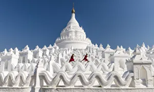 Two Buddhist novice monks on the white pagoda of Hsinbyume (Myatheindan) paya temple Two Buddhist novice monks on the white pagoda of Hsinbyume (Myatheindan) paya temple