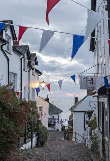 Bunting above the cobbled streets of Clovelly at dawn, North Devon, England. Summer Bunting above the cobbled streets of Clovelly at dawn, North Devon, England. Summer