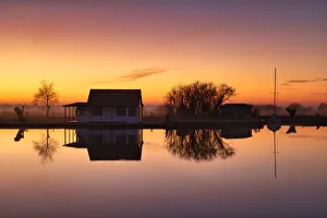 Cabin Reflecting in River Thurne at Sunset, Norfolk Broads National Park, Norfolk Cabin Reflecting in River Thurne at Sunset, Norfolk Broads National Park, Norfolk