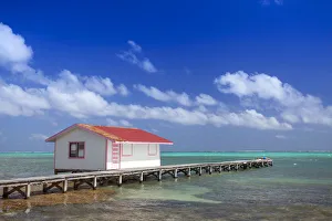 Central America, Belize, Ambergris Caye, San Pedro, a red hut on a jetty contrasted Central America, Belize, Ambergris Caye, San Pedro, a red hut on a jetty contrasted