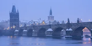 Charles Bridge and Old Town Bridge Tower against snowy sky in winter, Prague, Bohemia Charles Bridge and Old Town Bridge Tower against snowy sky in winter, Prague, Bohemia