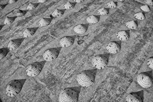 Children weave in and out of scores of giant cones as they roll bike tyres around a rice Children weave in and out of scores of giant cones as they roll bike tyres around a rice